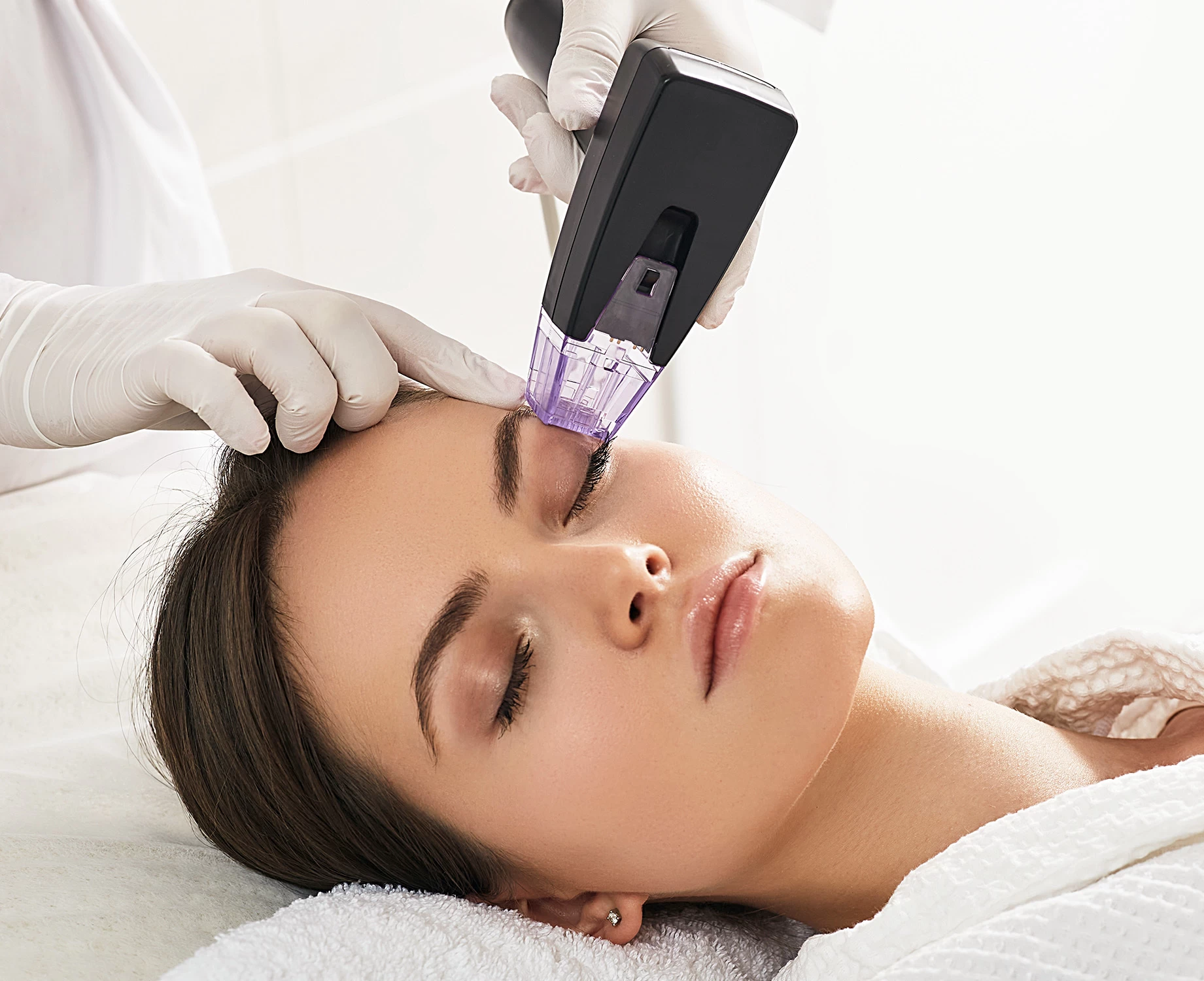 Morpheus8 treatment being performed on a woman's eyelid.