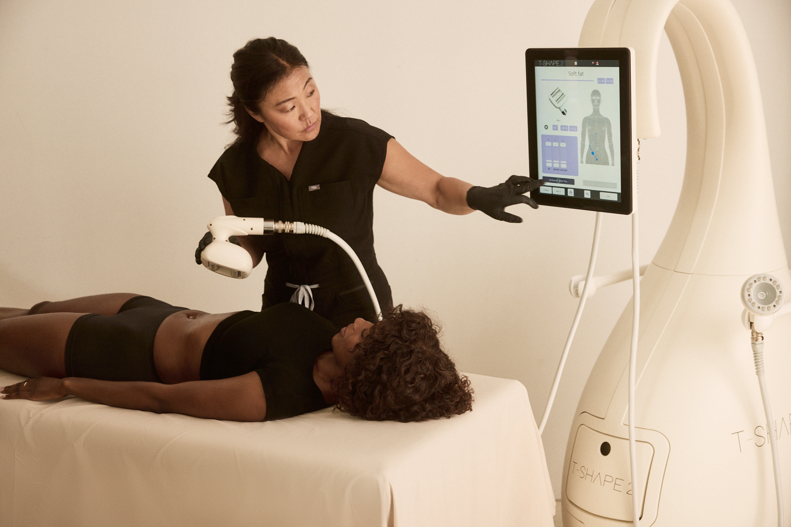 Stacey Krizan using the T-Shape 2 device screen while holding the Roll handpiece.